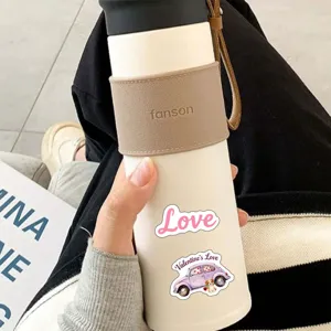 Close up of portable insulated tumbler cup with leather sleeve and cute sticker design.
