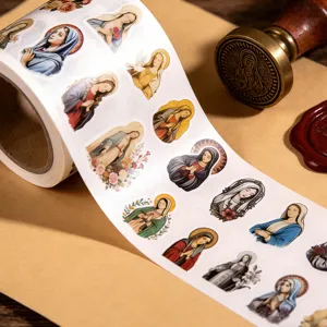Close-up detail of vintage religious sticker roll featuring classic saint illustrations, craft.