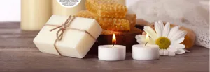 Natural handmade soap with candles and honeycomb setup for cozy home spa and decor use.