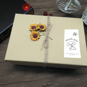 Detailed view of cute cartoon dog thank you sealing sticker on gift box, perfect for gifts.