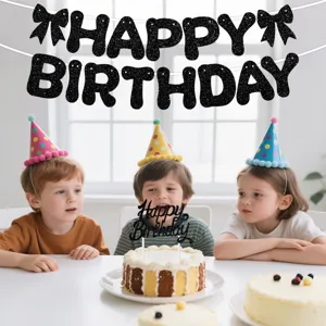 Detailed view of black glitter happy birthday banner and cake topper in party setting.