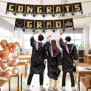 Graduation party decoration banner set with black and gold glitter letters and balloons.