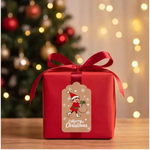 Festive red Christmas gift box with elegant ribbon bow and decorative elf holiday tag detail.