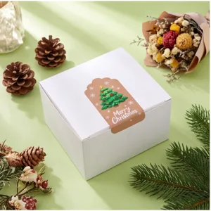 Christmas gift box detail view showcasing decorative pine cones and festive seal sticker.