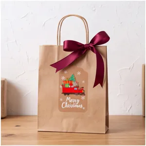 Christmas gift bag detail view featuring festive train sticker and elegant wine red ribbon bow.