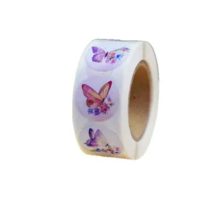 Roll of round butterfly and flower stickers, decorative adhesive labels for crafts and gifts.