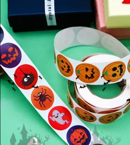 Close-up detail of Halloween pumpkin ghost spider sticker rolls for festive gift decoration.