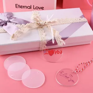Close-up of clear acrylic blank circle keychain pendants with gift box and DIY decorative ropes.