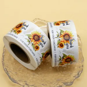 Rolls of sunflower thank you stickers for gift bags, bakery sealing, and small business packaging.