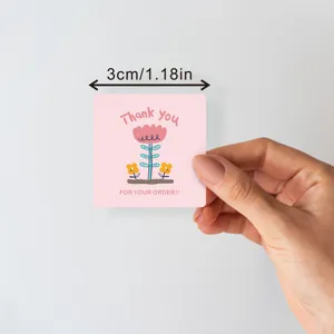 Square thank you sealing sticker with cute pink flower design for packaging and crafts.