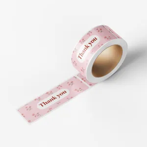 Pink thank you sticker roll detail close up, floral pattern decorative sealing label.