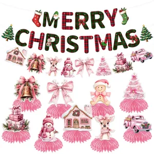 Detailed view of pink Christmas honeycomb centerpieces and Merry Christmas banner decorations for party.