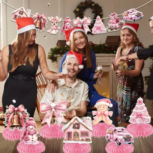 Pink Christmas honeycomb table centerpieces and hanging banner decor for holiday party.