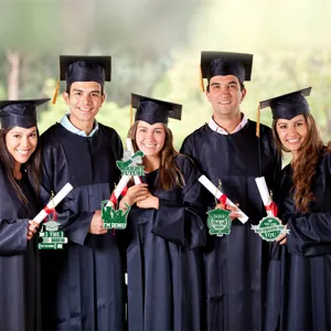 Graduation party hanging ornament detail showing green glitter tags with festive slogans.