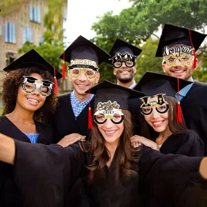 Graduation photo booth paper glasses props with gold glitter design for grad party decoration.