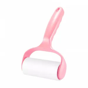 Pink lint roller for pet hair removal, tearable sticky paper roller for clothes cleaning.