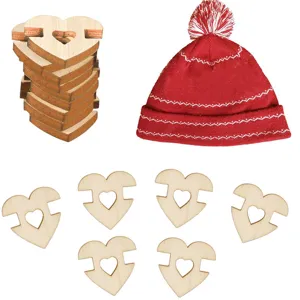 Detail shot showing wooden heart button fasteners and red pom pom hat for DIY craft projects.