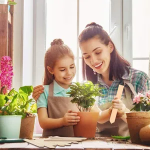 Wooden plant labels in a gardening lifestyle scene with children, natural wooden plant markers.