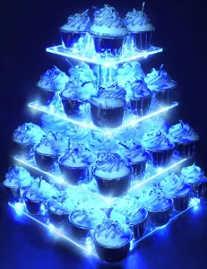 Detail view of the four-tier clear acrylic square cupcake stand lit by vibrant blue LED lights.
