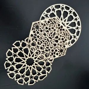 Close-up detail shot of intricate wooden hollow carved geometric star coasters and mats.