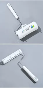 Lint roller detail view, white plastic handle and protective cover, pet hair remover tool