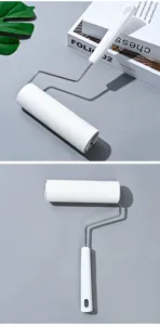 Detail view of white sticky lint roller with metal handle for pet hair removal and dust cleaning.