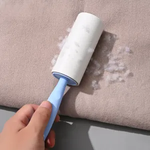 Portable lint roller with blue handle for clothes and pet hair removal, easy tear design.