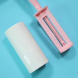 Pink sticky lint roller with white refill paper for clothes hair removal tool 10cm