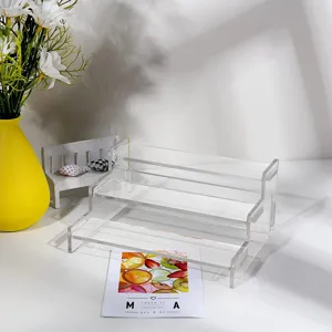 Clear acrylic 3-tier display stand detail showing transparent steps and sturdy assembly design.