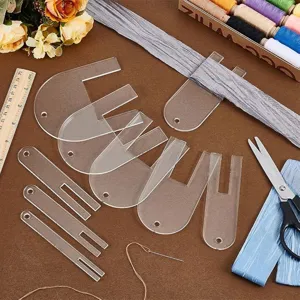 Detailed view of clear acrylic fabric pleating tools for sewing, precise craft accessories.
