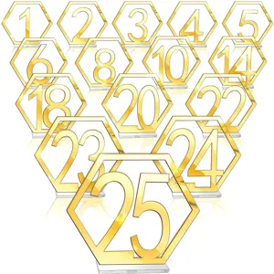 Gold acrylic hexagonal table numbers with clear bases for wedding parties and restaurant decor.