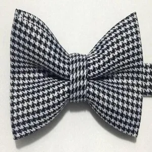 Classic black and white houndstooth bow tie, British style men's formal accessory for wedding.