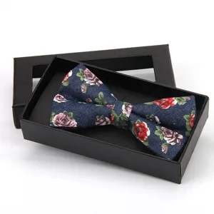Elegant blue floral fabric bow tie packaged in a black gift box for men's formal wear.