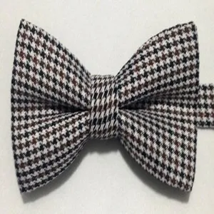 Detailed shot of classic houndstooth bow tie in black and brown pattern, elegant men accessory.