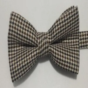 Classic houndstooth bow tie for men, elegant British style fabric accessory detail view.