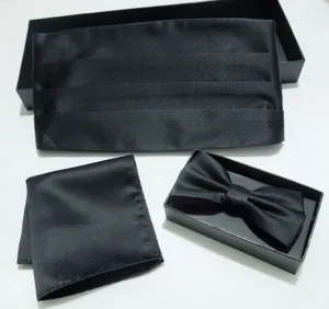 Men's black tuxedo accessory set detail featuring cummerbund, bow tie, and pocket square.
