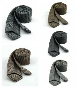 Men's wool plaid tie detail showing classic British style arrow design for business and banquet.