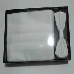 Detailed shot of white men formal cummerbund and bow tie set in black box, wedding accessory.