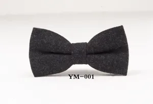 Close-up detail of dark grey wool bow tie, textured fabric for formal business wear.