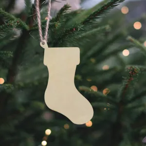 Close-up detail of unfinished wooden Christmas stocking ornament with string for DIY tree decor.