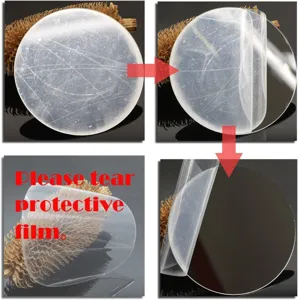 Round acrylic mirror wall sticker detail showing protective film peeling process for decor.