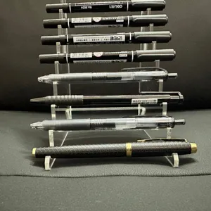 Clear acrylic tiered pen holder detail view showing multi-layer stationery desktop display.