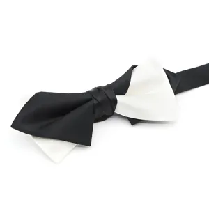 Detail shot of the classic black and white layered bow tie, featuring glossy fabric.