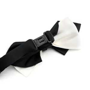 Black and white bow tie for men, adjustable strap, elegant formal wear accessory detail.