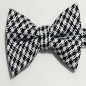 Detailed view of a classic black and white houndstooth bow tie with elegant British style.