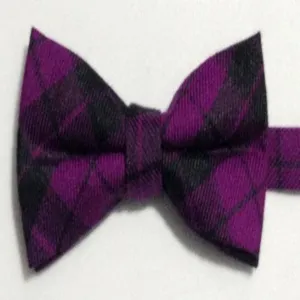 Detailed close-up view of the purple and black plaid bow tie, stylish British textile accessory.
