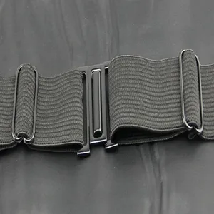Detail view of men's formal tuxedo cummerbund black elastic strap with metal adjustment buckles.