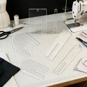 Clear acrylic sewing pleating template set for garment making and fabric folding guides.