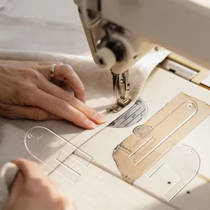 Clear acrylic sewing template tool for precise fabric pleating and professional crafting work.