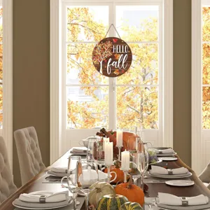 Wooden autumn hanging sign with Hello Fall text and maple tree in a festive room setting.